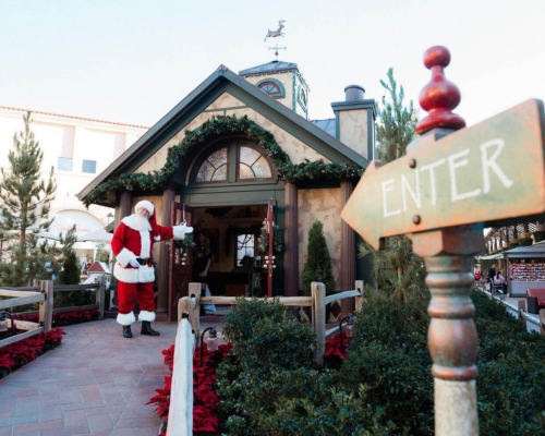 santa in front of cottage
